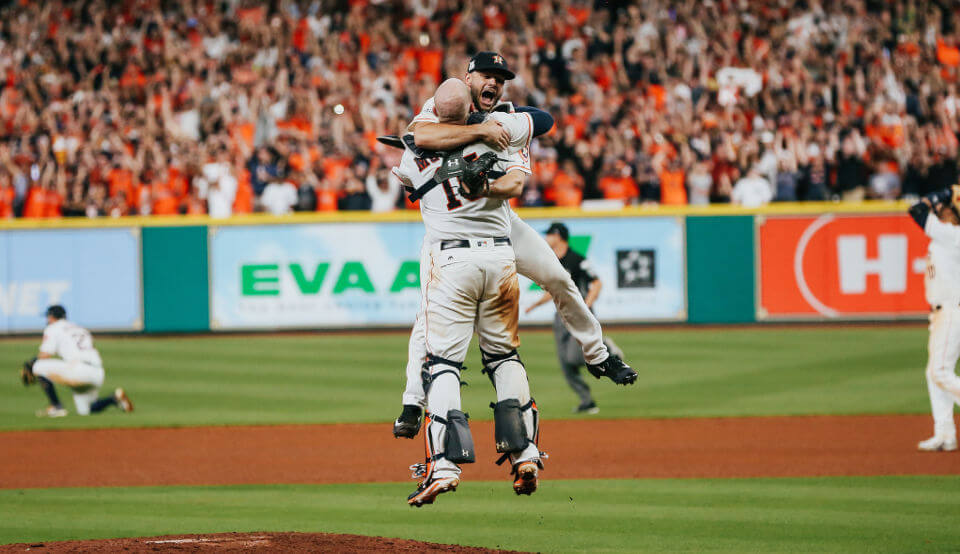 Two baseball players hugging in celebration.